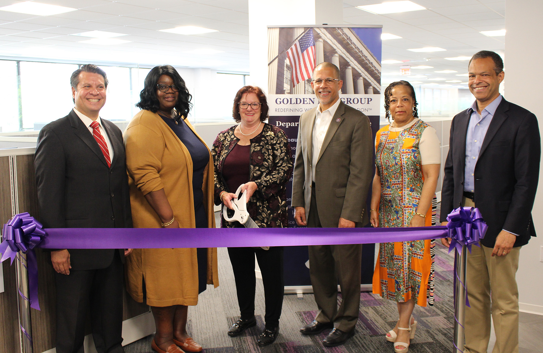 Six professionals at a ribbon-cutting ceremony for the Golden Key Group.